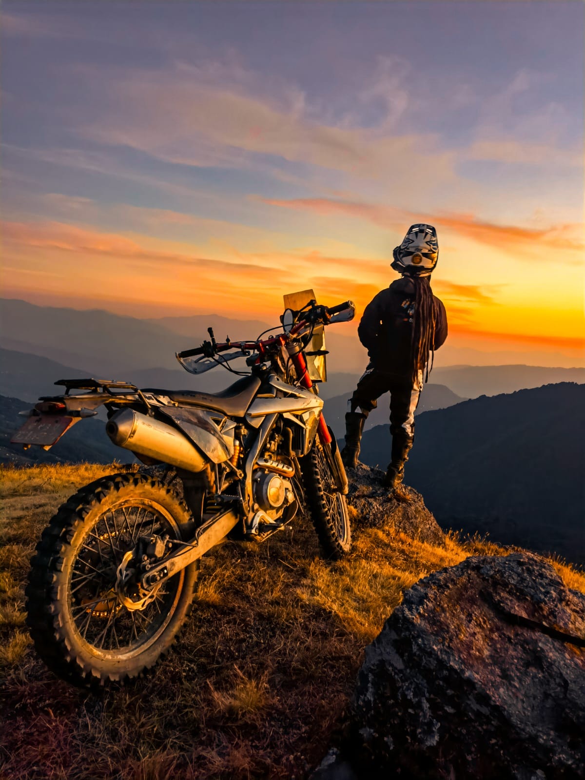 Rider hopping rocks at a waterfall crossing